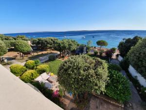 an aerial view of a park with the ocean in the background at Comfortable family apt Iris 20m from beach in Mandre in Mandre