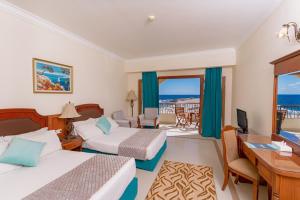 a hotel room with two beds and a desk at Life Resorts Coral Hills Beach & SPA in Quseir