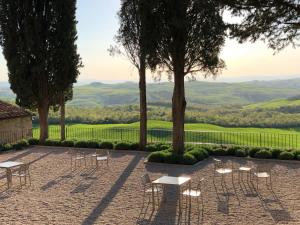 a group of tables and chairs with a view at Fattoria Monastero Sant'Anna in Camprena in Pienza