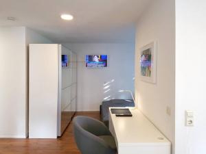 a room with a white desk and a chair at Designer Wohnung Schlößle 2 in Steinenbronn