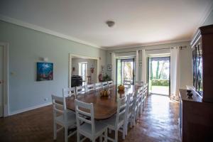 a dining room with a wooden table and chairs at Quinta da Paciencia in Sintra