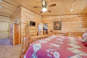 a bedroom with a bed and a ceiling fan at Broken Bow Cabin with Hot Tub and Covered Deck! in Stephens Gap