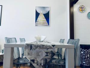 a white dining room table with chairs and a christmas tree at Luna 4 - 176 in Lignano Sabbiadoro