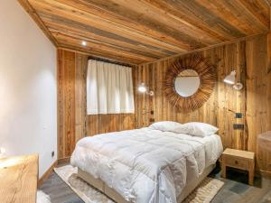 a bedroom with a large bed and a mirror at Appartement Val-d'Isère, 4 pièces, 8 personnes - FR-1-694-102 in Val-d'Isère