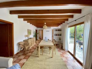 a living room with a table and chairs in a room at Encant in Pollença