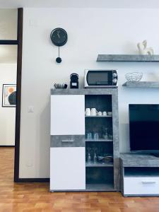 a kitchen with a counter with a microwave at Luna 4 - 176 in Lignano Sabbiadoro
