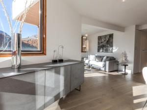 a kitchen and living room with a view of the mountains at Appartement élégant contemporain avec balcon sud et wifi - FR-1-694-170 in Val dʼIsère