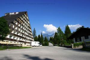 a white truck parked next to a building at Apartments in Bad Mitterndorf - Steiermark 41117 in Bad Mitterndorf