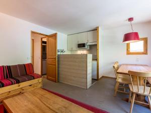 a living room with a couch and a table at Appartement Val-d'Isère, 5 pièces, 8 personnes - FR-1-694-151 in Val-d'Isère