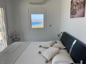 a bedroom with a bed with a view of the ocean at Villa Franck I in Sitia