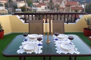 a table with glasses of wine and candles on a balcony at Giannis Traditional House in Vamos