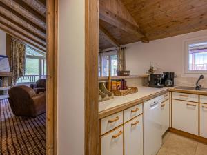 a kitchen with white cabinets and wooden ceilings at Appartement Val-d'Isère, 3 pièces, 5 personnes - FR-1-694-216 in Val-d'Isère