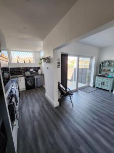 a room with a kitchen and a living room at Delightful newly renovated 3-bed house with garden beach hut in Blackpool