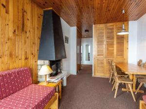 a living room with a table and a fireplace at Appartement 2 pièces rénové, animaux acceptés, vue panoramique - FR-1-694-243 in Val dʼIsère