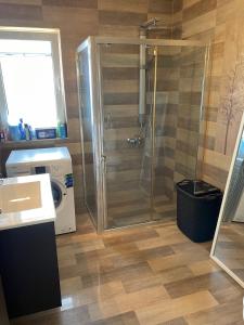 a bathroom with a shower and a washing machine at Villa Franck I in Sitia