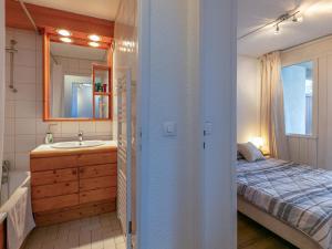 a bathroom with a bed and a sink and a tub at Appartement skis aux pieds avec parking couvert et WiFi au cœur de Val d'Isère - FR-1-694-259 in Val dʼIsère