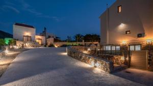 a driveway leading up to a house at night at Pink Sand-Studio in Agios Padeleimon