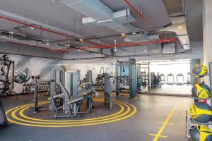 a fitness room with a gym with tread machines at LUXFolio Retreats - In The Heart Of Marina in Dubai Marina