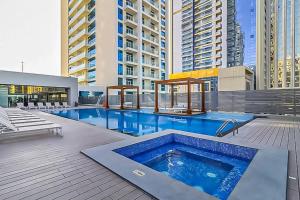 a swimming pool on top of a building with tall buildings at LUXFolio Retreats - In The Heart Of Marina in Dubai Marina