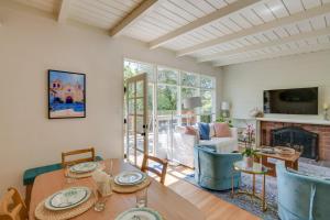 a living room with a table and a fireplace at Vacation Rental Home about 1 Mi to Carmel Beach! in Carmel