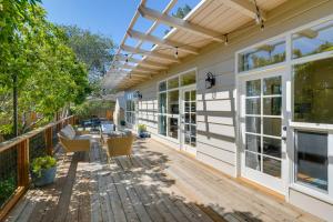 a patio with a table and chairs on a wooden deck at Vacation Rental Home about 1 Mi to Carmel Beach! in Carmel