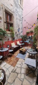 an outdoor patio with tables and chairs and a building at Casa 39 Apartments in Rovinj