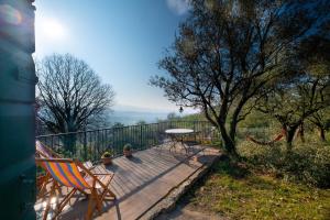a wooden deck with a table and chairs on it at Ca Del Vajo Valpolicella House in Negrar