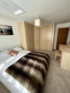 a bedroom with a large black blanket on a bed at The Annexe at Firs House in Bedford