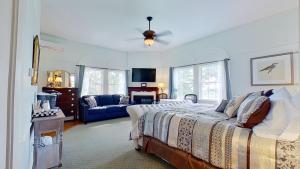 a bedroom with a bed and a blue couch at John Joseph Inn in Groton