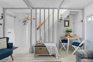 a living room with a staircase and a table and chairs at Family Tides Brixham in Brixham