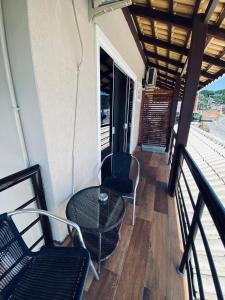 un balcón con mesa y sillas en el porche en Hotel Lorimar, en Penha
