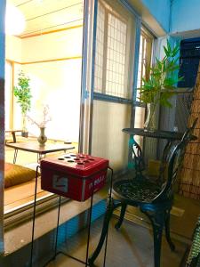 a room with a table and a red box on a chair at 新宿新大久保駅日本和の宿 in Tokyo +17 photos