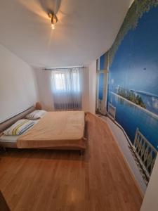 een slaapkamer met een bed en een schilderij aan de muur bij Anita Medulin Apartment in Medulin