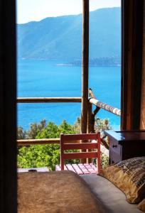 a bedroom with a view of the ocean at Deep Ocean Camping-Adults Only in Faralya