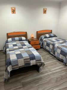 Postel nebo postele na pokoji v ubytování Apartamentos Joaquina