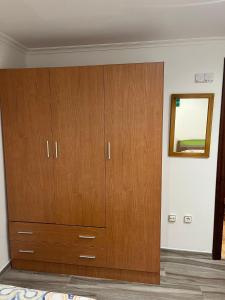 a large wooden cabinet in a room at Apartamentos Joaquina in Tagle