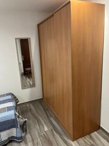a large wooden cabinet in a room with a mirror at Apartamentos Joaquina in Tagle