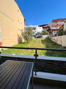 a balcony with a table and a view of a field at Oasis in Sarti