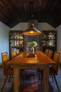 a dining room table with a vase of flowers on it at Eastwind Hotel Lake Placid in Lake Placid