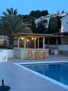 a villa with a swimming pool and a house at Casa El Sueño in Jávea