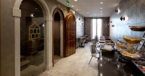 a kitchen with a table and a dining room at Alle Guglie Boutique Hotel in Venice