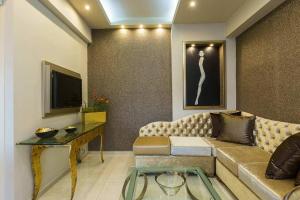 a living room with a couch and a tv at Eleanna's Luxury Home in Rethymno Town