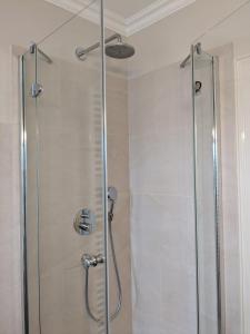 a shower with a glass door in a bathroom at Haus Flora in Keitum