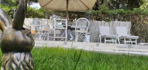 a group of chairs and an umbrella in a yard at DomusAuroom, il tuo RELAX in Viareggio