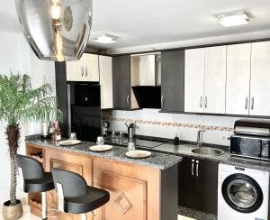 cocina con encimera con 2 lavabos y lavavajillas en Modern 2 Bedroom Apartment Fuengirola en Fuengirola
