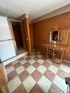 a room with a table and a tiled floor at Hotel Villa Del Rey in Zaragoza