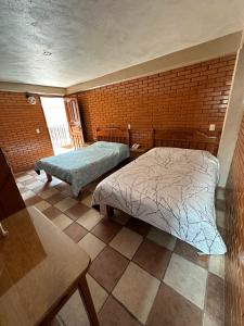 a bedroom with two beds in a room at Hotel Villa Del Rey in Zaragoza