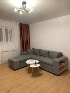 a living room with a couch and a table at Sunny Apartment in Suceava in Suceava