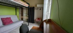 Zimmer mit einem Bett, einem Sofa und einem Fenster in der Unterkunft chambre familiale dans maison au calme in Segonzac