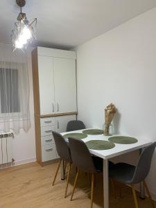a dining room with a table and chairs at Sunny Apartment in Suceava in Suceava
